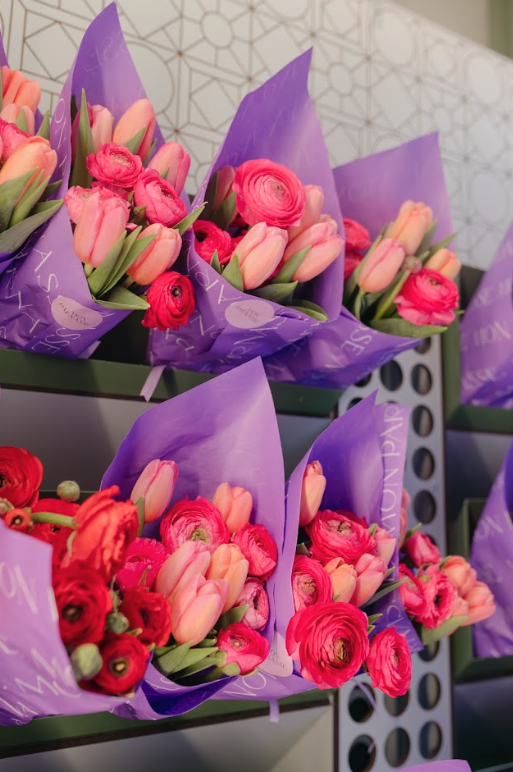 Ramos de tulipanes y ranúnculos en la estantería de la tienda